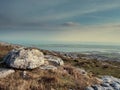 Burren National park, View from a mountain on Galway bay, Calm cloudy sky, Rough terrain and big stones in foreground. Concept Royalty Free Stock Photo