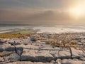 Burren National park, View from a mountain on Galway bay, Hazy sunny day, Rough terrain and big stones in foreground. Concept Royalty Free Stock Photo