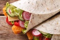 Burrito with fish fingers, and vegetables macro. Horizontal top Royalty Free Stock Photo