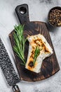 Burrito with grilled chicken and vegetables, fajitas, shawarma. White Wooden background. Top view