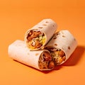 Burrito roll with chicken and vegetables on orange background - fast food concept