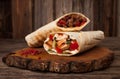 Burrito and shawarma wraps with beef and pork vegetables on wooden table. Copy space for text Royalty Free Stock Photo