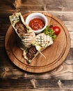 Burrito or tortilla served in restaurant, cafe. Flatbread with pork Royalty Free Stock Photo