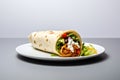 Burrito wrap with vegetables, meat and sauce