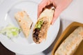 Burrito wraps with pulled pork, beans, rice and vegetables on white plate Royalty Free Stock Photo