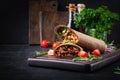 Burritos wraps with beef and vegetables on  dark wooden background. Royalty Free Stock Photo