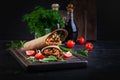 Burritos wraps with beef and vegetables on dark wooden background. Royalty Free Stock Photo