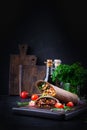 Burritos wraps with beef and vegetables on dark wooden background. Royalty Free Stock Photo