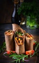 Burritos wraps with beef and vegetables on dark wooden background. Royalty Free Stock Photo