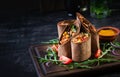 Burritos wraps with beef and vegetables on dark wooden background. Royalty Free Stock Photo