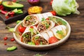 Burritos wraps with beef and vegetables on a wooden background. Beef burrito , mexican food. Healthy food background. Royalty Free Stock Photo