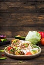 Burritos wraps with beef and vegetables on a wooden background Royalty Free Stock Photo