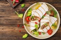 Burritos wraps with beef and vegetables on a wooden background Royalty Free Stock Photo