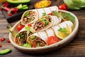 Burritos wraps with beef and vegetables on a wooden background. Royalty Free Stock Photo