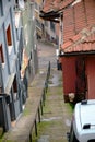 Narrow street and old houses roof made of red bricks in bursa.