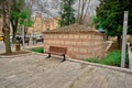 Somuncu baba tomb near the old entrance gate of Bursa saltanat kapisi with single public bench made of wooden material and peopl