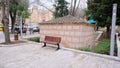 Somuncu baba tomb near the old entrance gate of Bursa saltanat kapisi with single public bench made of wooden material and peopl