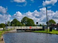 An electric swing bridge at New Lane on the Leeds to Liverpool Canal near Burscough in Lancashire, UK