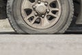 Burst car tire on street. Royalty Free Stock Photo