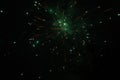 Burst of green and orange fireworks at night - vibrant streaks and sparks - smoke clouds - celebration, new years day, fourth of Royalty Free Stock Photo
