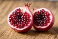 A burst pomegranate reveals its succulent seeds, each one packed with flavor and bursting with juicy goodness, a