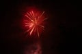 Burst of red fireworks at night - vibrant streaks and sparks - smoke clouds - celebration, new years day, fourth of july, canada Royalty Free Stock Photo