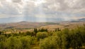 A burst of sunshine over the rolling hills of Tuscany Royalty Free Stock Photo