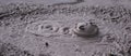 Bursting mud bubble in a geothermal pool in NZ Royalty Free Stock Photo
