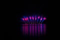 Bursts of blue and violet fire in rich fireworks over Brno`s Dam with lake reflection Royalty Free Stock Photo