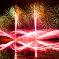 Bursts of Green, Orange and Pink Fireworks