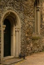 Vintage church wooden door in medieval flint stone archway with , Suffolk, UK - July 22nd 2020