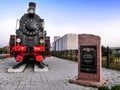 An old steam locomotive and a memorial plate to the partisan railroad workers at the Putyvl