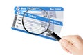 Bus boarding pass tickets with magnifier glass in hand Royalty Free Stock Photo