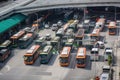 bus depot during busy rush hour, with buses departing and arriving every minute