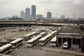 bus depot with view of the city skyline, with tall buildings and busy streets visible