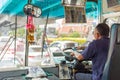 Bus driver drives bus in Bangkok