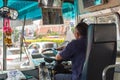 Bus driver drives bus in Bangkok