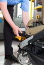 Bus driver helping a passenger with stroller board