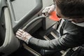 Bus Driver Sanitizing Railings Using Alcohol in Spray