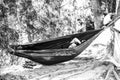 Bus driver sleeps in a hammock during his lunch break in Da Lat, Vietnam