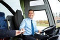 Bus driver taking ticket or card from passenger Royalty Free Stock Photo