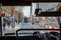 A bus drivers perspective of a busy city street seen from the inside.