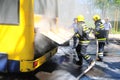 Bus on fire on the street in the middle of the day Royalty Free Stock Photo