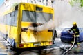Bus on fire on the street in the middle of the day Royalty Free Stock Photo