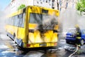 Bus on fire on the street in the middle of the day Royalty Free Stock Photo