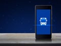 Bus flat icon on modern smart mobile phone screen on wooden table over fantasy night sky and moon, Business transportation service Royalty Free Stock Photo