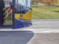 Bus front part on bus stop in the city ready to take passengers Royalty Free Stock Photo