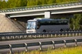 Bus goes on highway under bridge Royalty Free Stock Photo