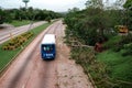 Bus on Havana road after a hurricane hit and fallen trees on the side of the road Royalty Free Stock Photo