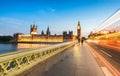 Bus light trails across Westminster Bridge with blurred moving p